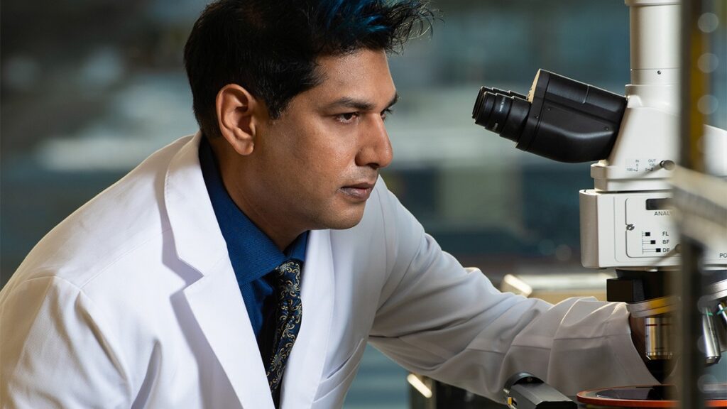 Nautilus co-founder and Chief Scientist Parag Mallick inspecting a microscope