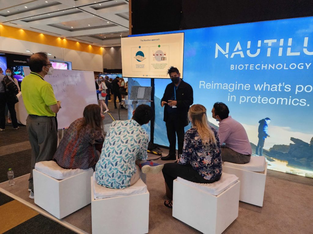 Photo of Nautilus founder and Chief Scientist, Parag Mallick, presenting at the Nautilus booth at HUPO 2022.